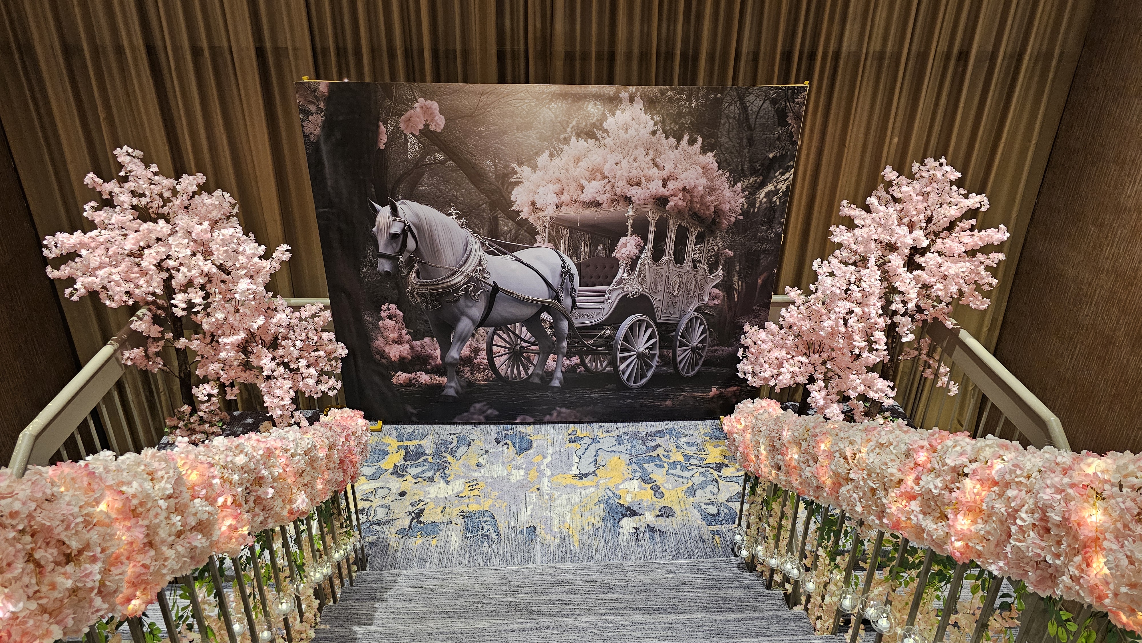 Romantic floral event entrance with carriage backdrop